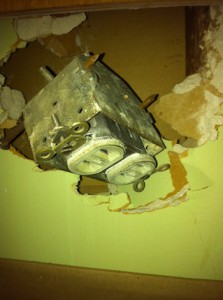 Mysterious electrical socket hidden in the wall.   Could this be the unknown device that our wall switch operates?